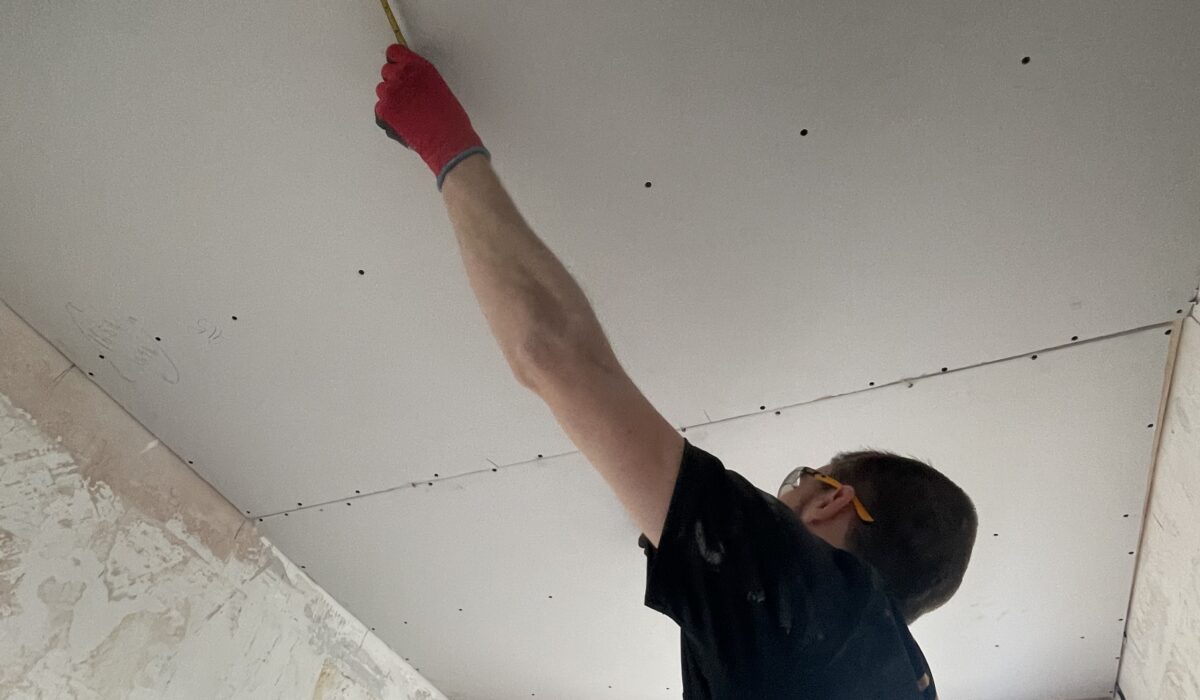 Ceiling plasterboard installed and temporary pendant light in place