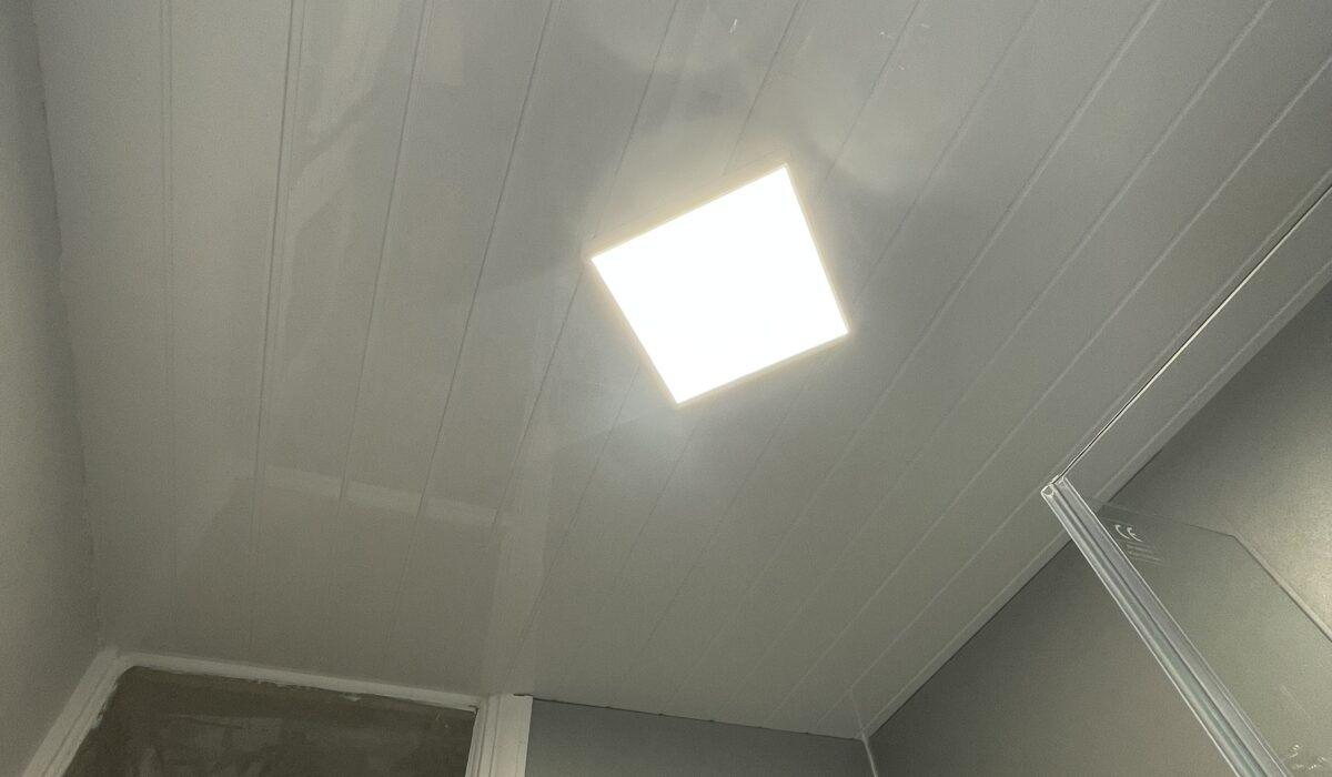 Square low profile LED luminaire installed in a diamond against the ceiling panels